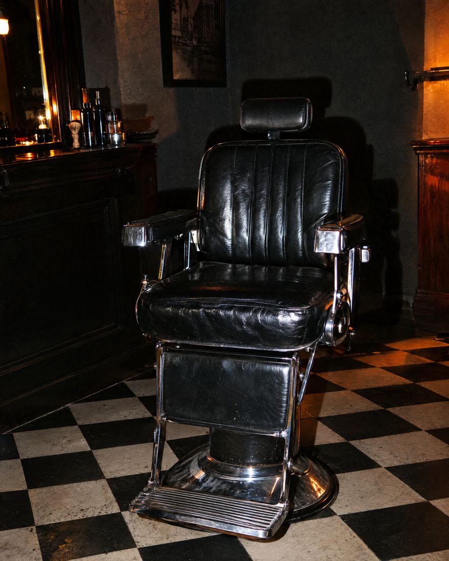 Empty barber chair at night
