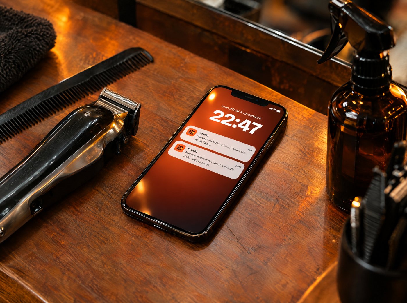 Phone on the barber's counter with a new booking notification