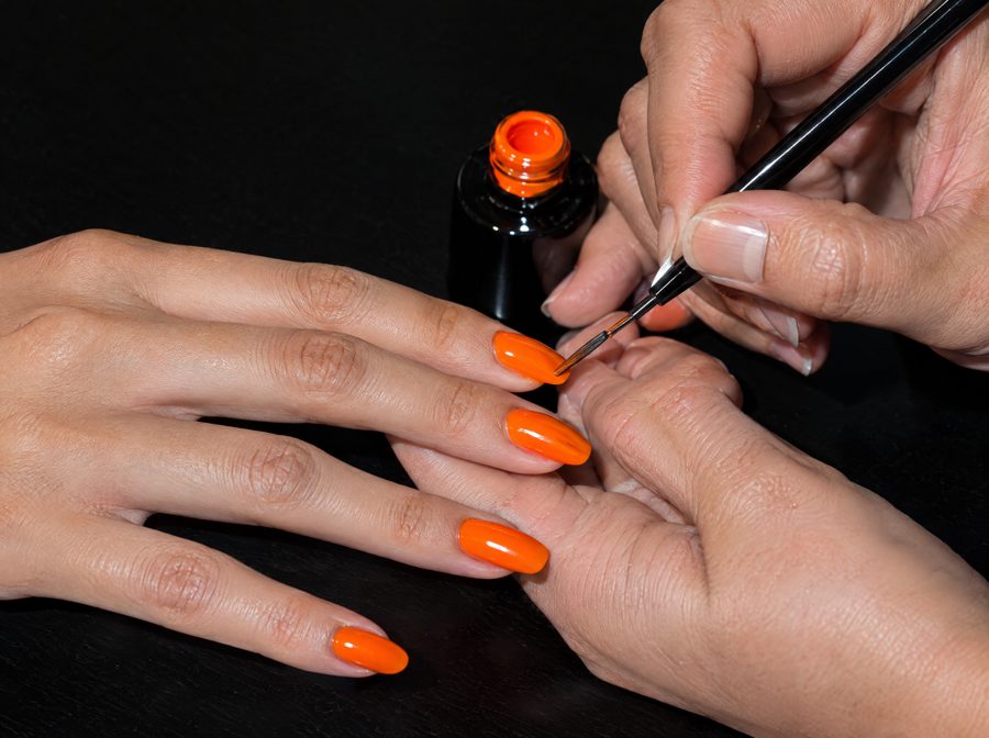 Orange polish on nails